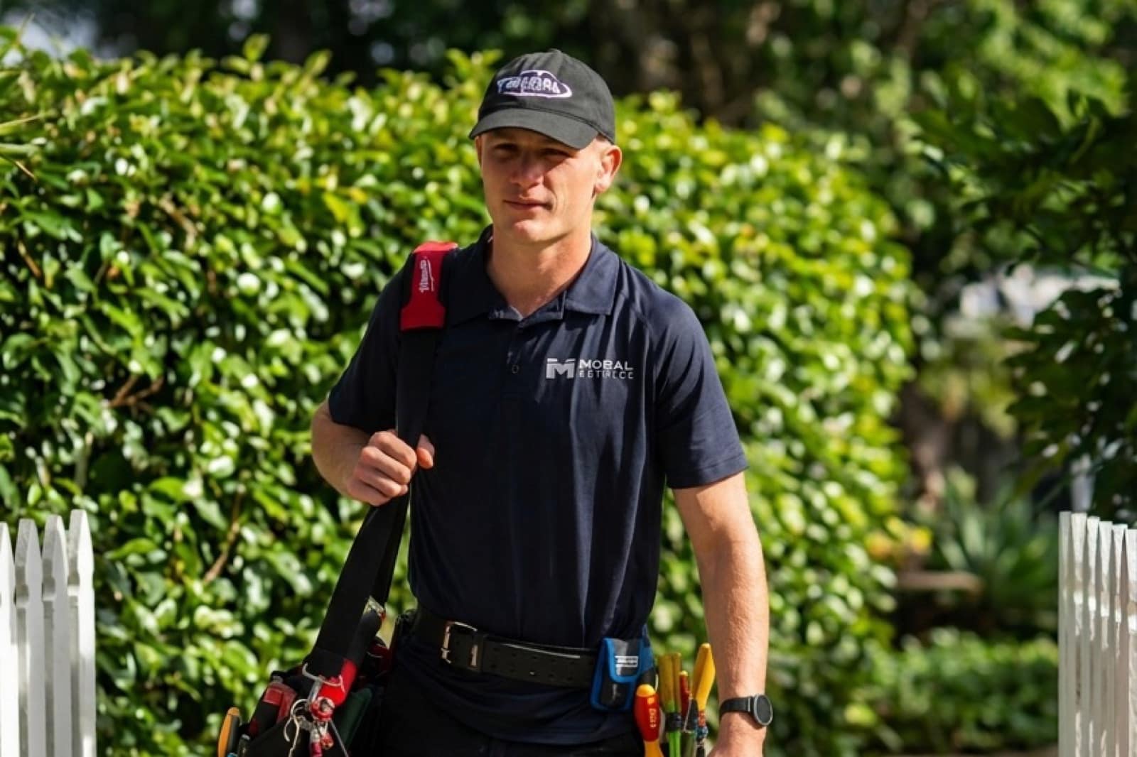 Justin from Moral Service walking in to a Gold Coast job with his tool bag and test gear