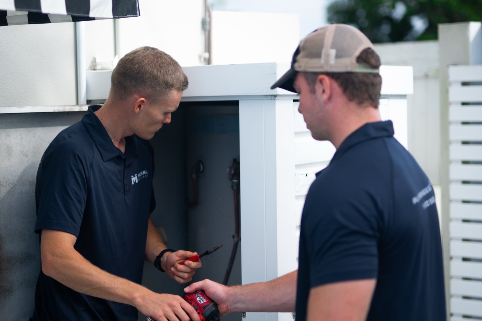 An outdoor hot water system being repaired at a Gold Coast home