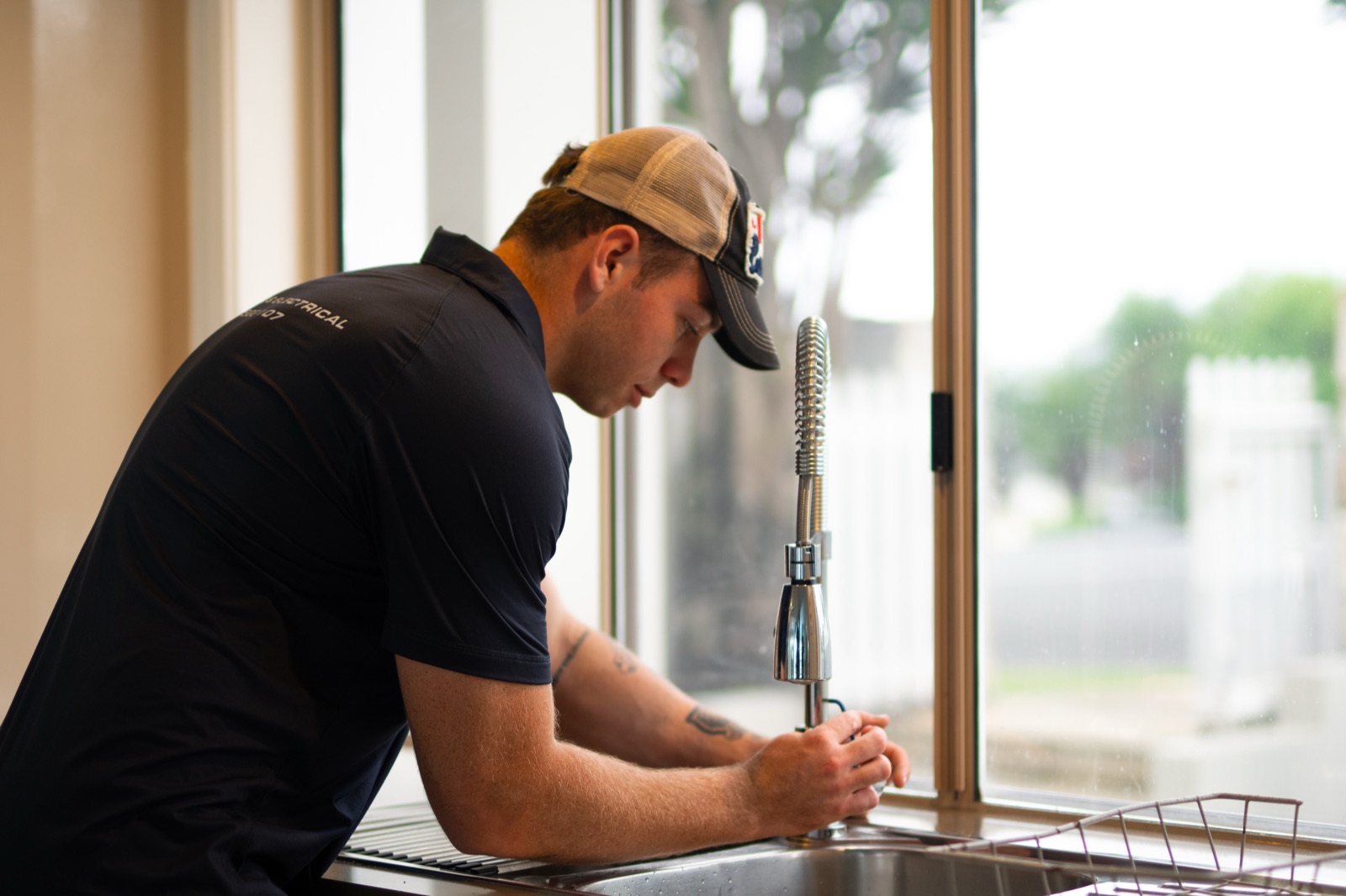 A Moral Service plumber fitting a new kitchen mixer tap