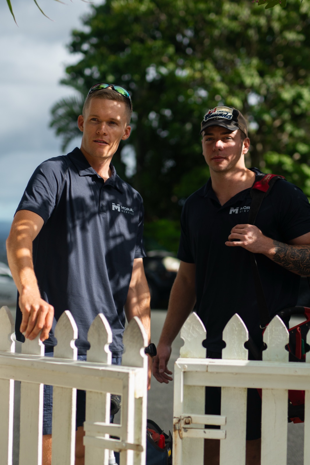 Two Moral Service tradesmen arriving at the white front gate of a Gold Coast home